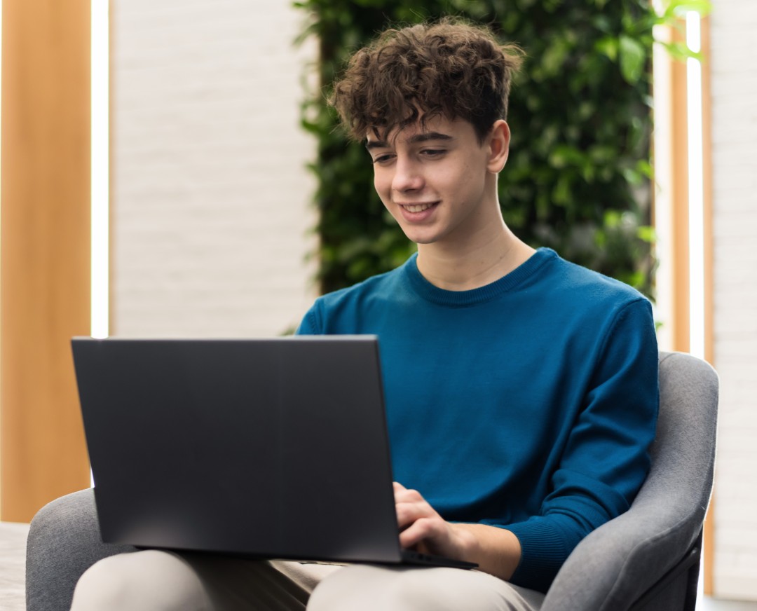 Student focused on writing notes in a classroom setting